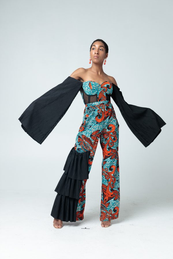 A Patterned Ankara Jumpsuit with Pleats on the right, Feathers around Cleavage, Corset style middle, Wide Mouthed - Pleated Off shoulder sleeves.