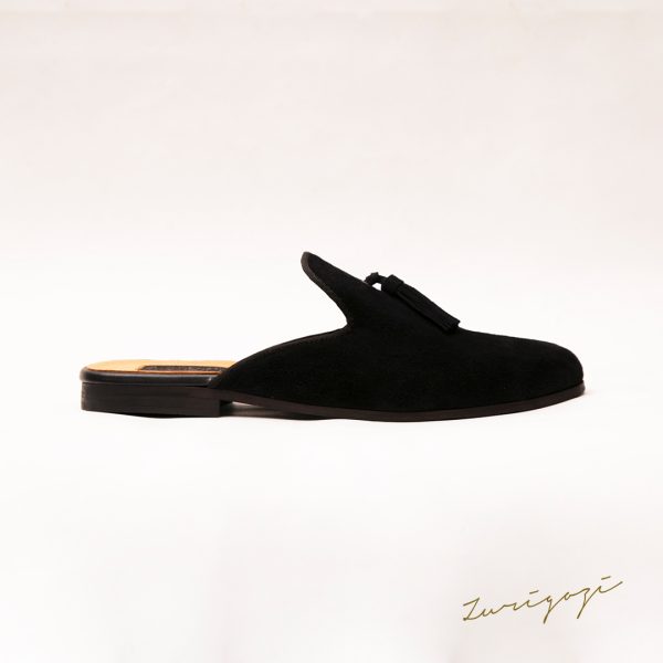 Elevate your style with Zuri Black Suede Mules featuring chic tassels. Step into sophistication and comfort with this classic half shoe. Shop now!