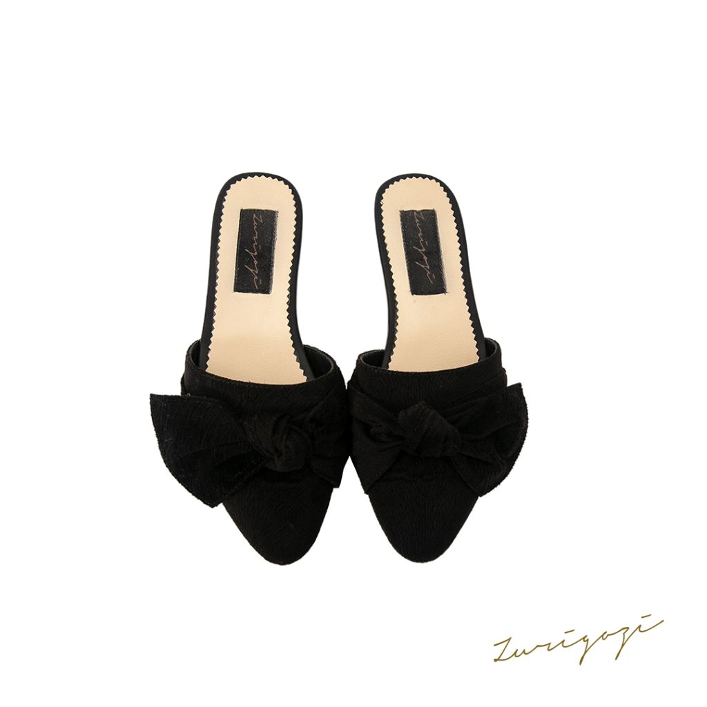 Chic and versatile female suede black mules with a bow for every occasion. Perfect for the office and the party, providing comfort and elegance. Shop now!