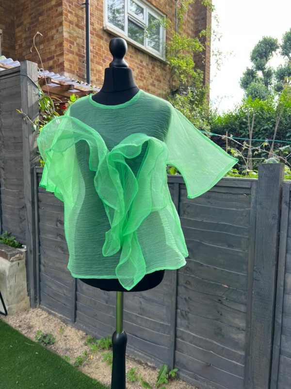 Discover elegance in our unique green chiffon blouse featuring exquisite ruffles. This enchanting piece is available in red, white, pink and cream colors!
