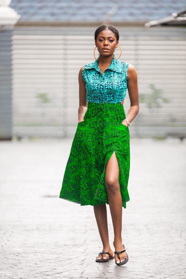 A mid-length African dress with a corporate flair. This dress boasts a mid-thigh slit and an open back, to attract attention as you walk. Shop Now!