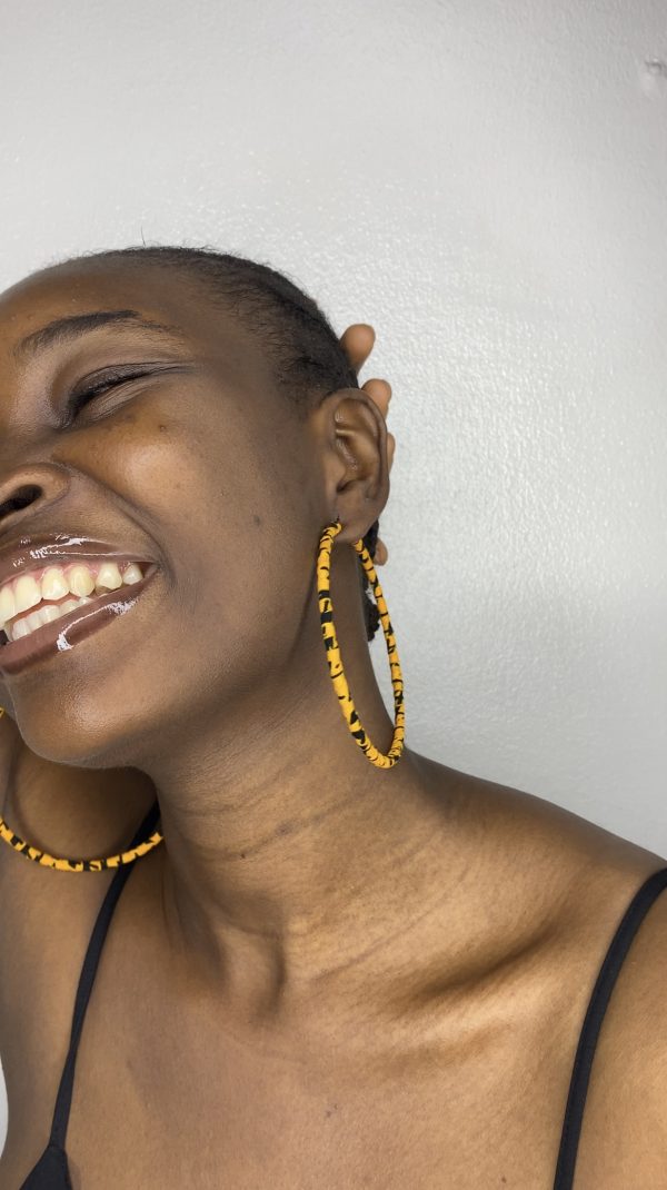 Elevate your look with these vibrant Ankara hoop earrings in dazzling yellow. Perfect for any outing, these earrings will add a pop of color and flair to your style.